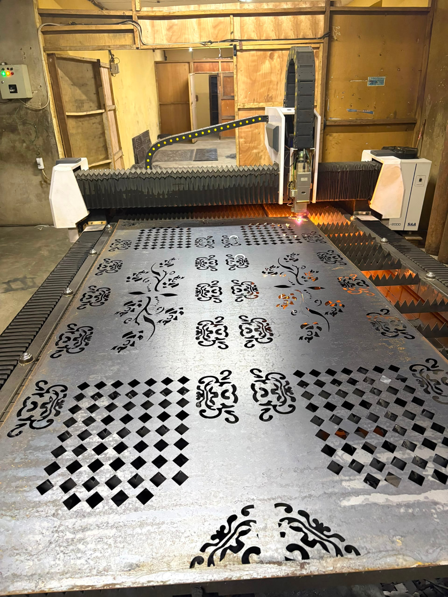 Decorative patterns laser cut into a steel sheet for architectural metalwork